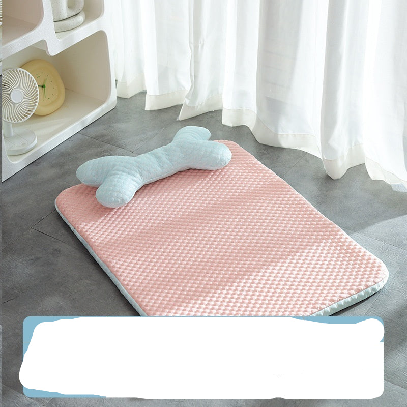 Pink bath mat with a bone-shaped towel on a gray floor, next to a white shelf with a fan and yellow item.