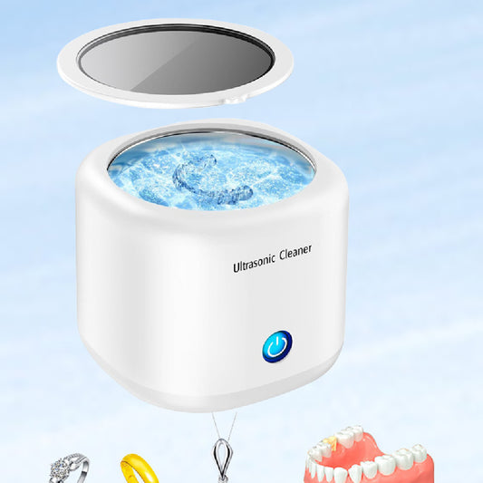 Ultrasonic cleaner with water in a white container on a light blue background