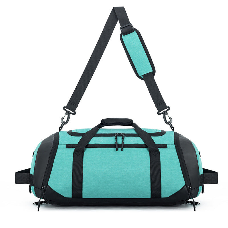 Turquoise duffel bag with black straps on a white background