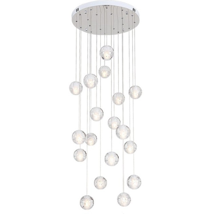 Modern pendant light with multiple spherical glass shades on a white background