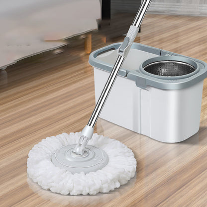 Mop with a white head and gray handle on a wooden floor.