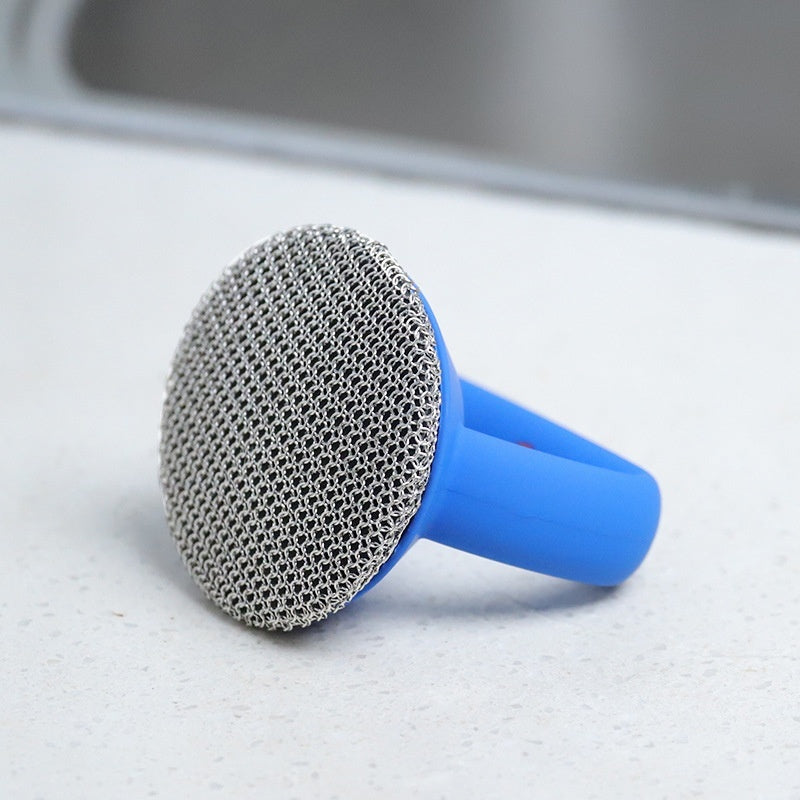 Metal scrubber with blue handle on a kitchen counter