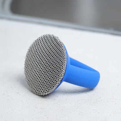 Metal scrubber with blue handle on a kitchen counter