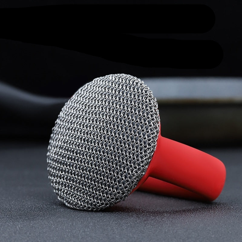 Patented pot scrubber with red handle on a dark surface, featuring a patent number.