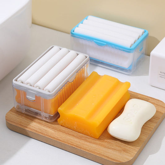 Bar of soap and two containers with rolled-up items on a wooden board.