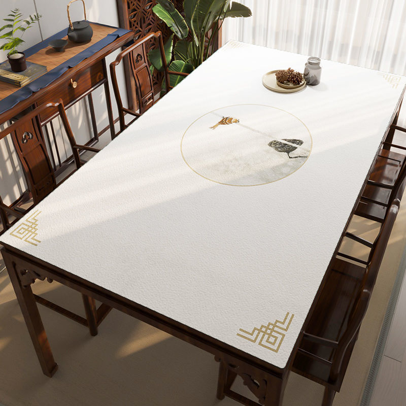 Dining table with a decorative mat featuring Chinese characters and a fish design.