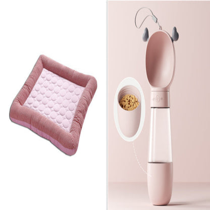Pink pet bed and food dispenser on a white background