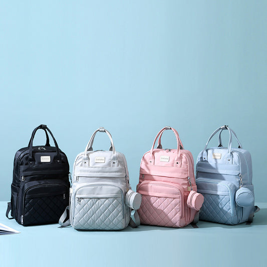 Four backpacks in black, white, pink, and blue on a light blue background