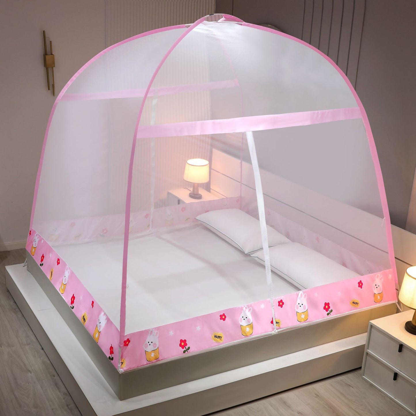 Pink children's bed canopy with cartoon designs on a bed in a bedroom.