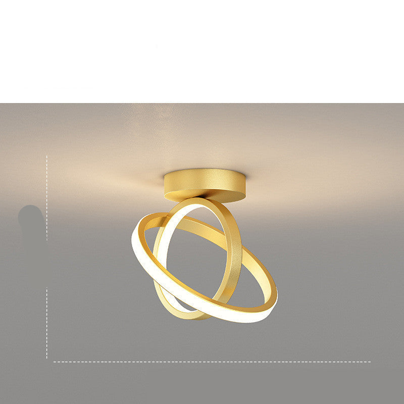 Modern ceiling light fixture with two interlocking rings on a neutral background