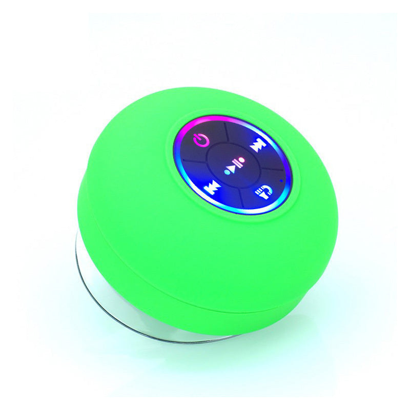 Green round Bluetooth speaker with control buttons on a white background