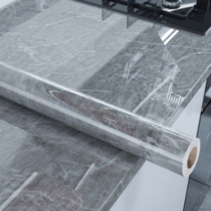 Roll of gray marble-patterned contact paper on a white surface