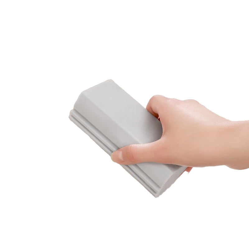Hand using a multi-functional cleaning brush in a sink with text indicating its features.