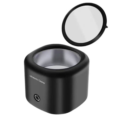 Black ultrasonic cleaner with a clear container on a white background