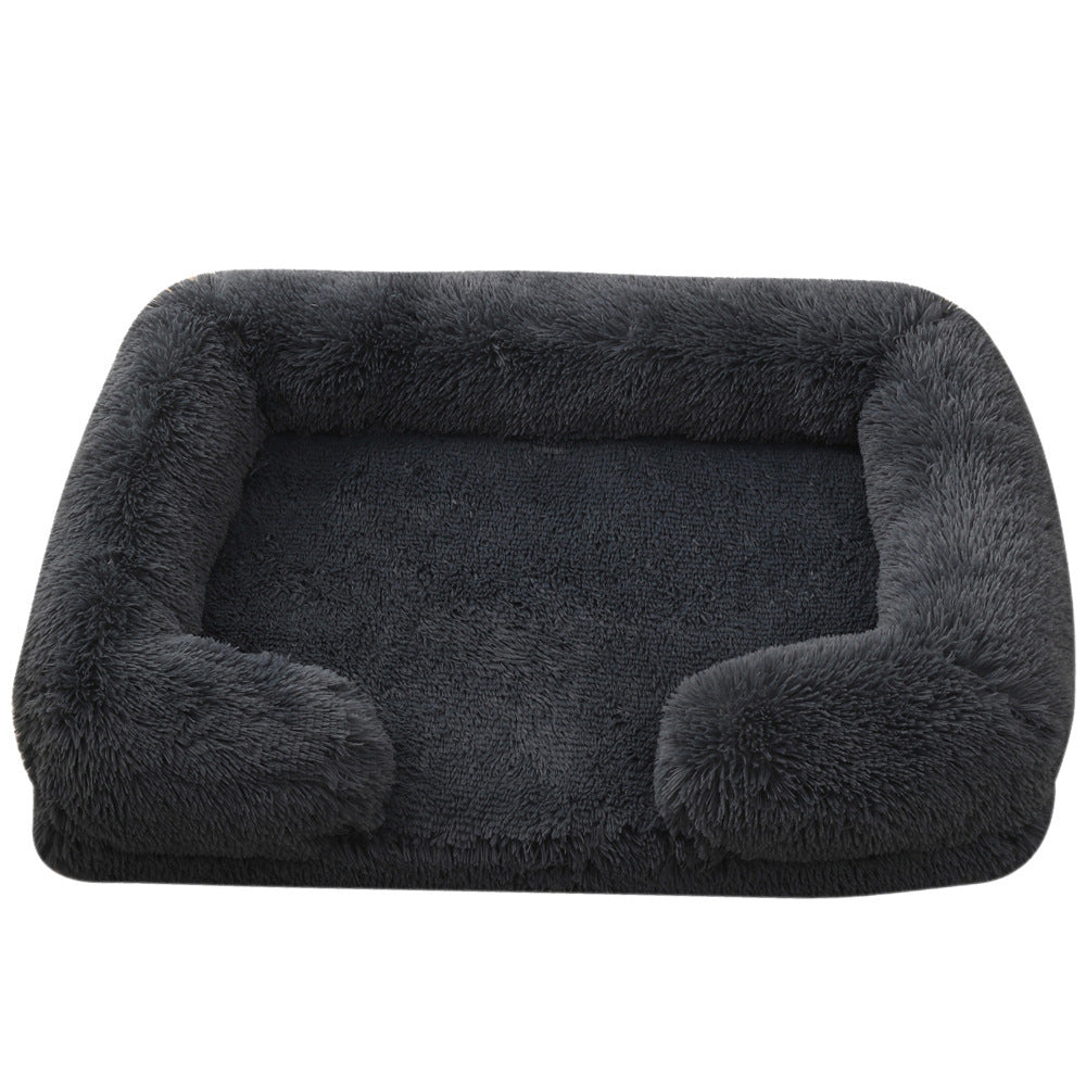 Dark gray pet bed with fluffy edges on a white background
