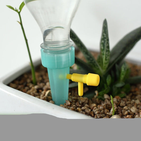 Automatic watering system for plants using a drink bottle and mineral water bottles.