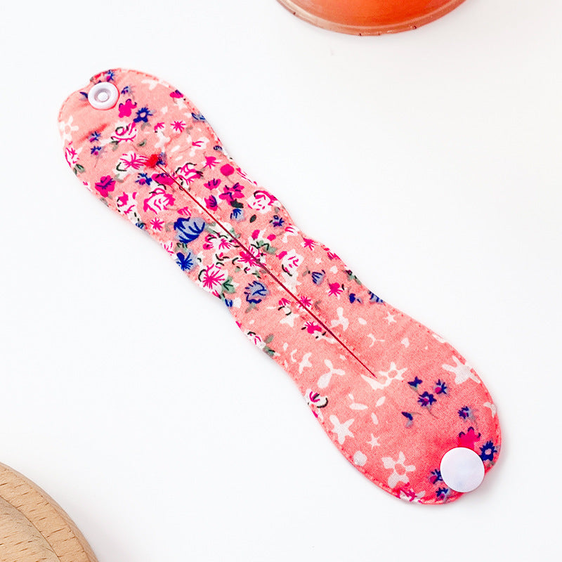Floral-patterned sanitary pad on a white background