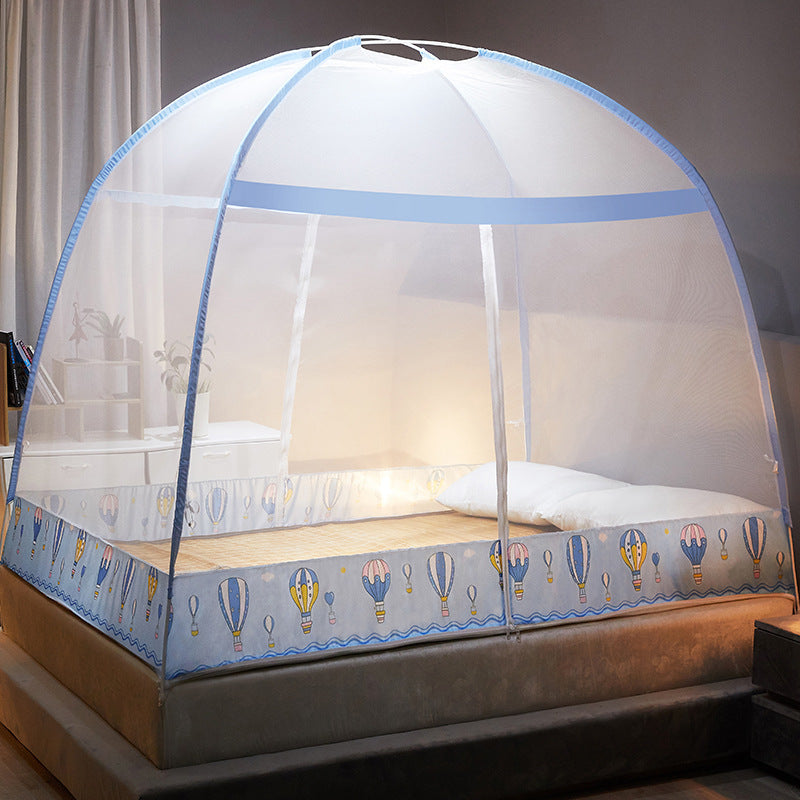 Bed with a mosquito net featuring hot air balloon design in a bedroom setting.