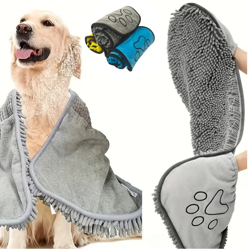 Dog wrapped in a gray towel with two additional towels and a paw-shaped item displayed.
