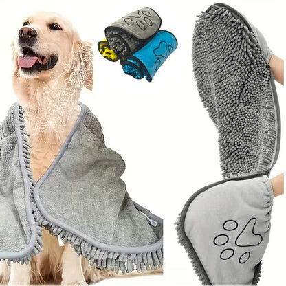 Dog wrapped in a gray towel with two additional towels and a paw-shaped item displayed.