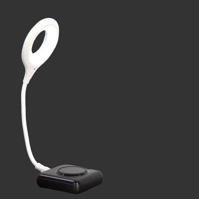 Remote emergency light with voice control feature on a bedside table.