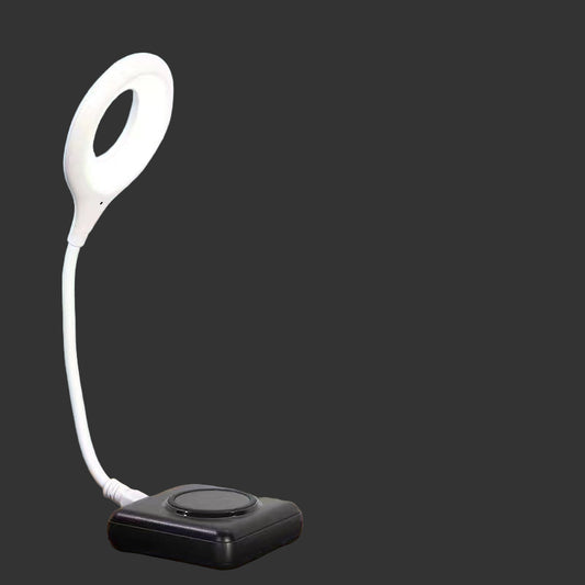 Remote emergency light with voice control feature on a bedside table.