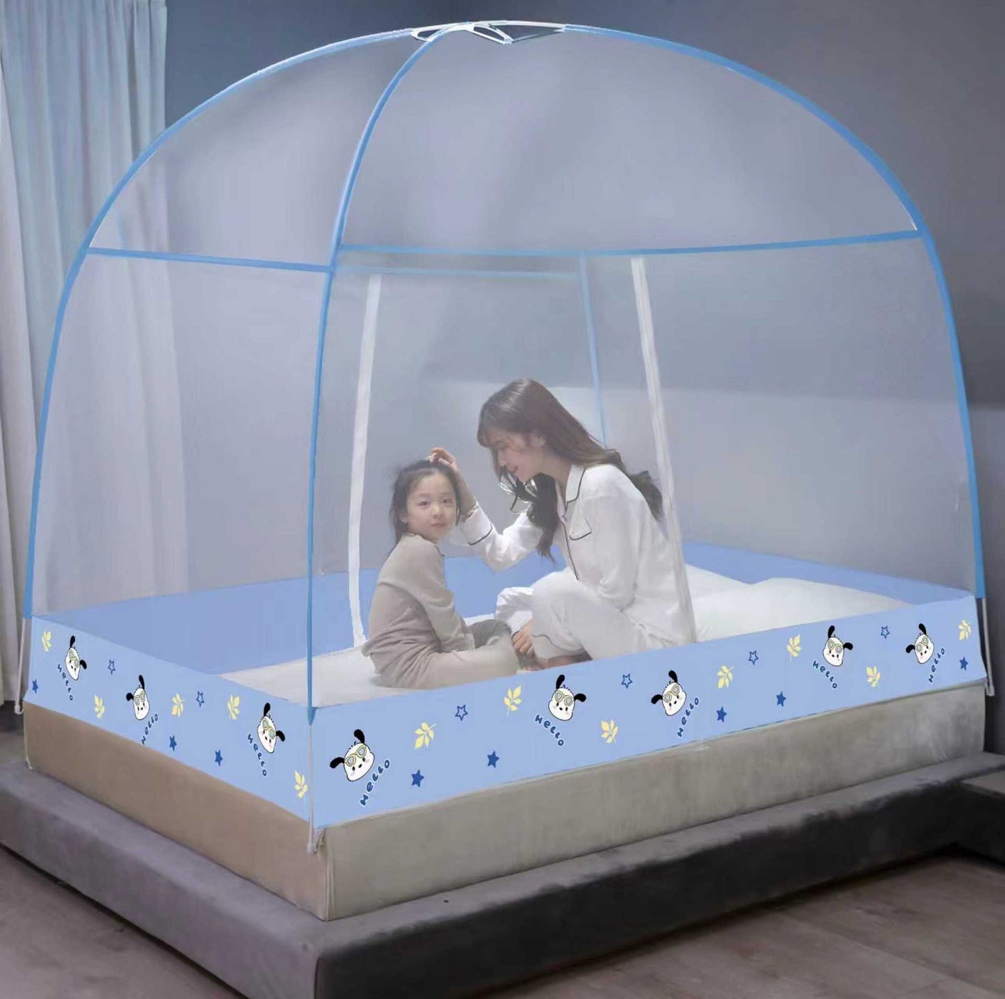 Children's bed with a mosquito net and cartoon designs on the mattress.